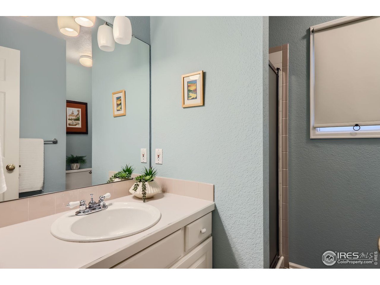 407 East Baseline Road Lafayette, CO 80026 - Photo 14 of 34 a bathroom with a sink vanity and a mirror