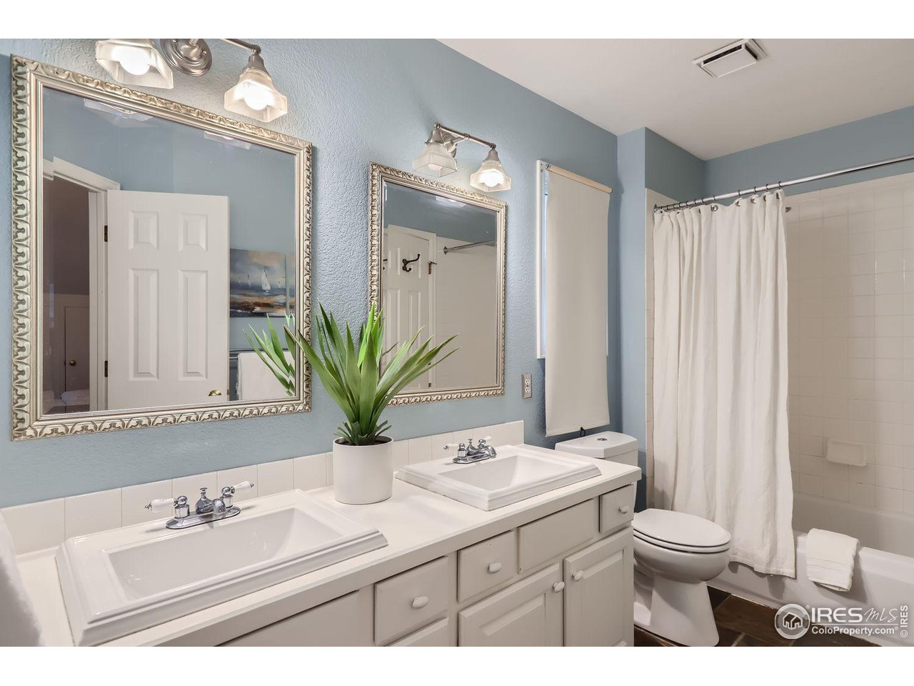 407 East Baseline Road Lafayette, CO 80026 - Photo 18 of 34 a bathroom with a sink a toilet and a large mirror