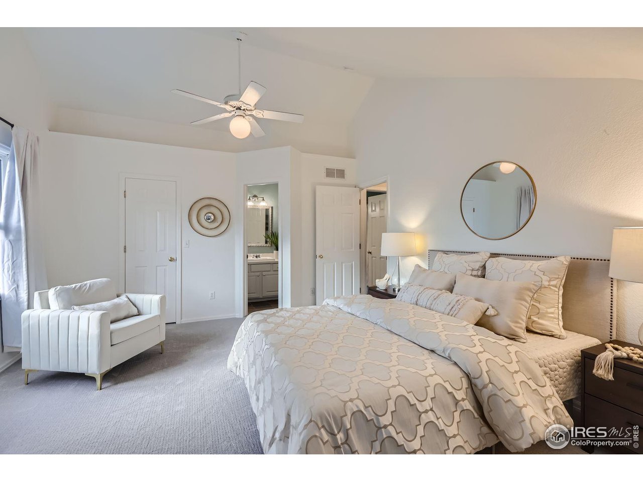 407 East Baseline Road Lafayette, CO 80026 - Photo 4 of 34 a bedroom with a bed and a chandelier