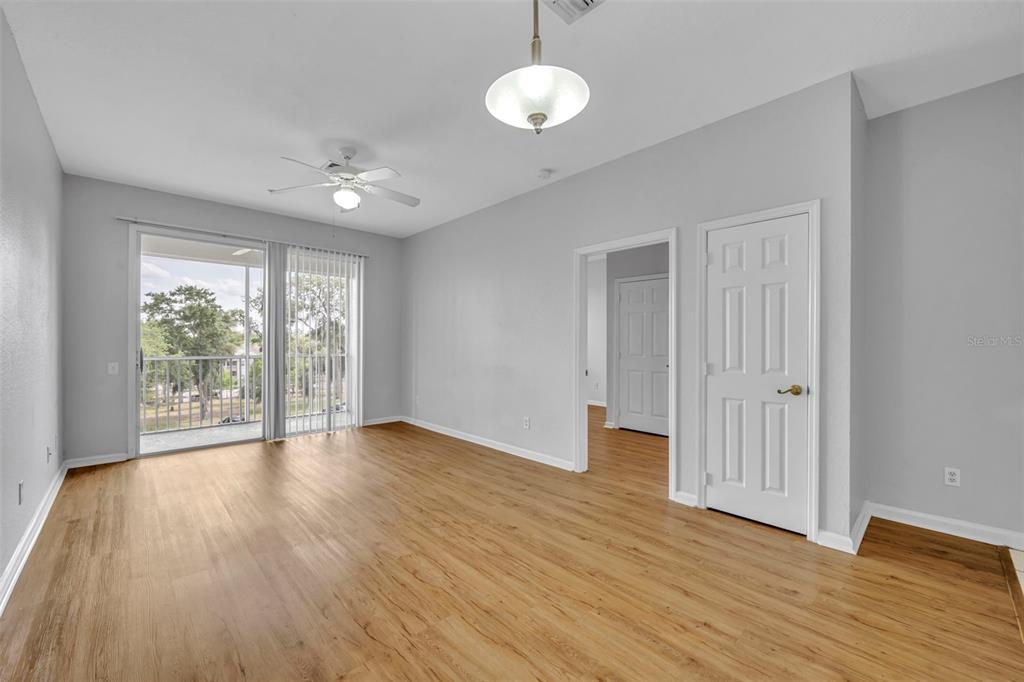 582 Brantley Terrace Way, Unit 304 Altamonte Springs, FL 32714 - Photo 11 of 30 an empty room with wooden floor and windows