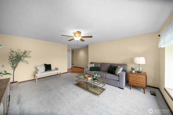 a living room with furniture and a chandelier