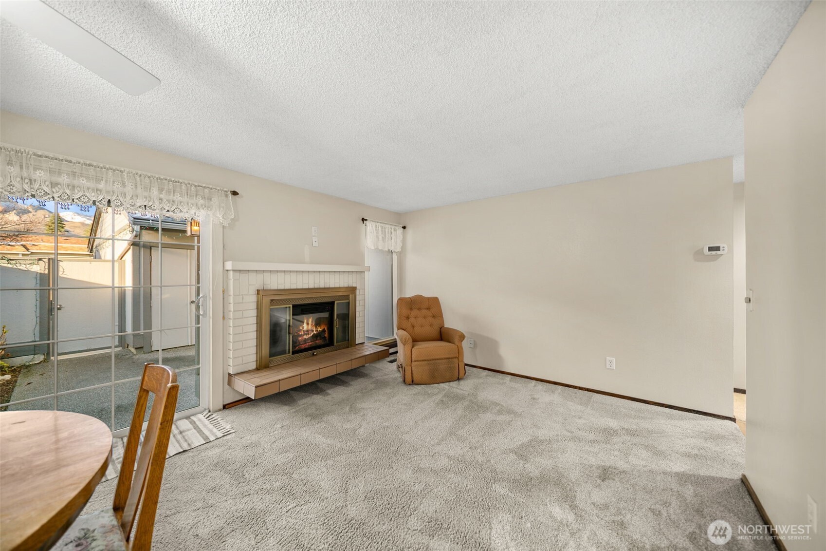 1310 Castlerock Avenue, Unit 9 Wenatchee, WA 98801 - Photo 13 of 33 a living room with furniture and a fireplace