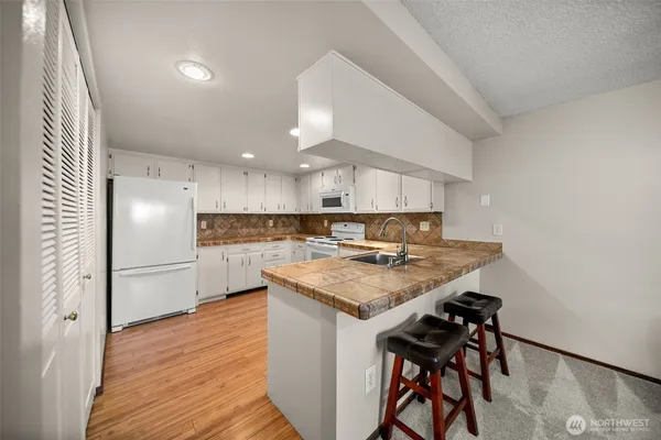 a kitchen with a table and chairs in it