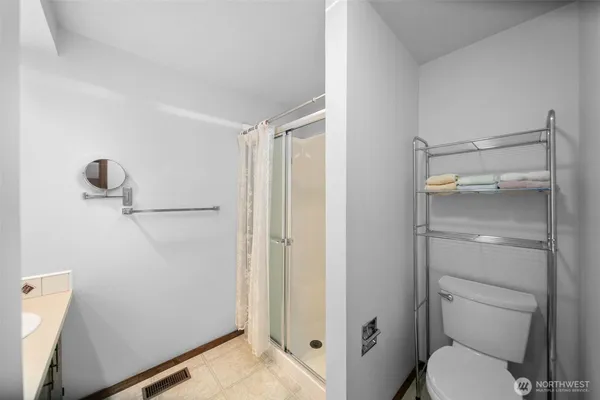 a bathroom with a shower toilet and sink