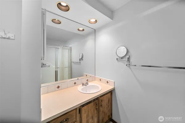 a bathroom with a sink mirror and vanity