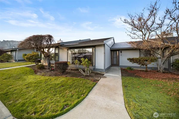 a view of a house with backyard porch and sitting area