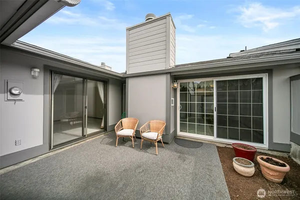 a backyard of a house with table and chairs