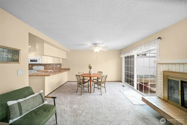 a kitchen with a dining table chairs and refrigerator