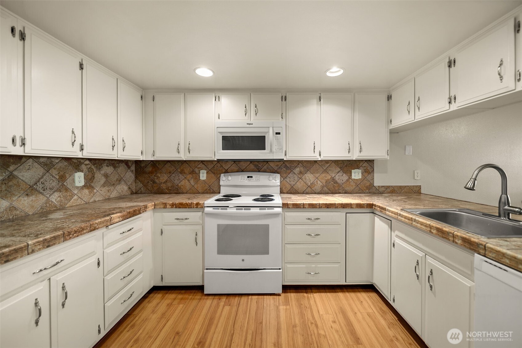 1310 Castlerock Avenue, Unit 9 Wenatchee, WA 98801 - Photo 6 of 33 a kitchen with cabinets appliances a sink and a window