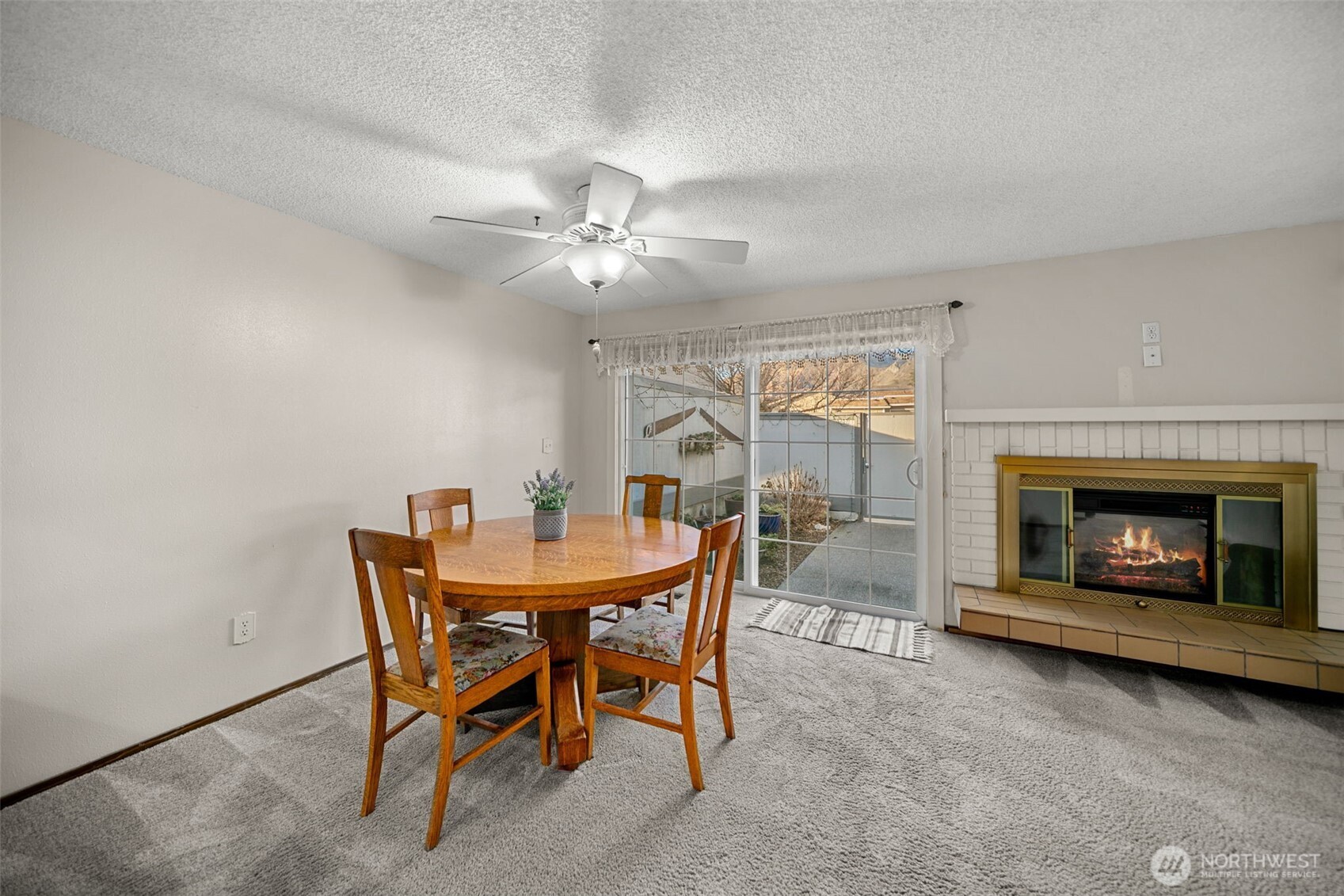 1310 Castlerock Avenue, Unit 9 Wenatchee, WA 98801 - Photo 9 of 33 a view of a dining room with furniture and a fireplace