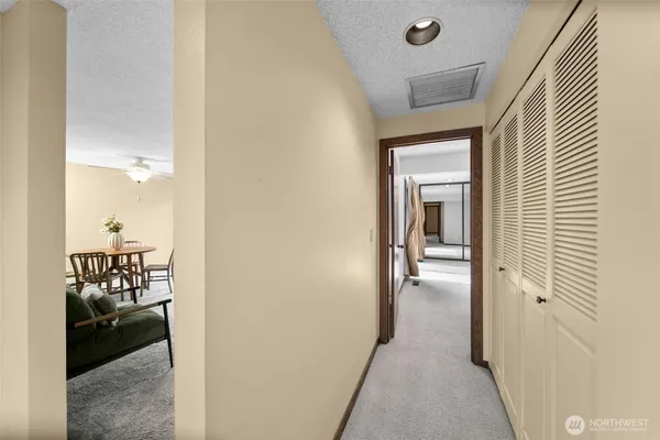 a view of a hallway to a livingroom and a couch