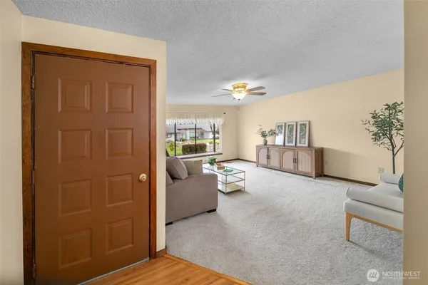 a living room with furniture and a potted plant
