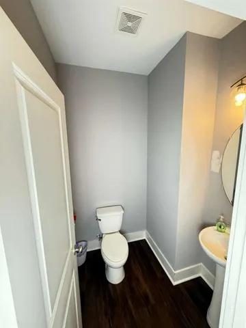 a bathroom with a toilet and a mirror