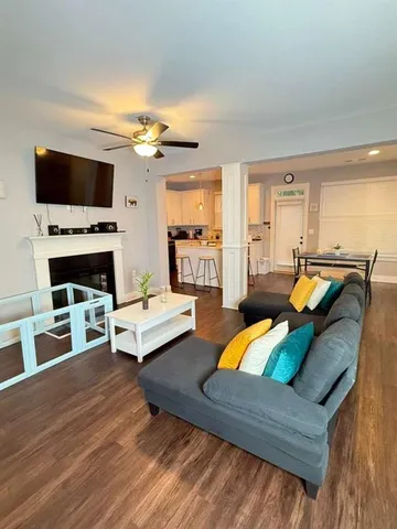 a living room with furniture fireplace and flat screen tv