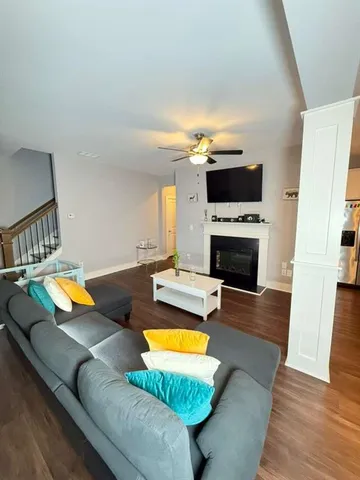 a living room with furniture pool table and a fireplace