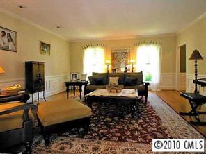 3901 Foxcroft Road Charlotte, NC 28211 - Photo 3 of 8 a living room with furniture a flat screen tv and a table