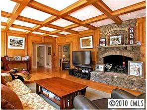3901 Foxcroft Road Charlotte, NC 28211 - Photo 4 of 8 a living room with furniture a flat screen tv and a fireplace