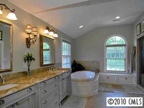 3901 Foxcroft Road Charlotte, NC 28211 - Photo 7 of 8 a spacious bathroom with a granite countertop toilet a sink and a large mirror