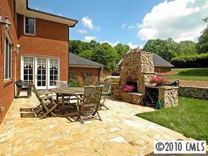 3901 Foxcroft Road Charlotte, NC 28211 - Photo 8 of 8 a view of a house with patio and a yard