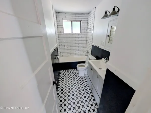 a bathroom with a sink a toilet and mirror