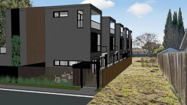 a view of a street with wooden fence