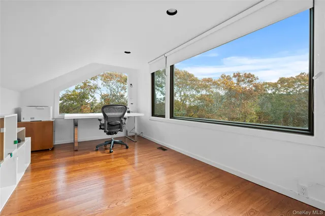 a work room with wooden floor and furniture
