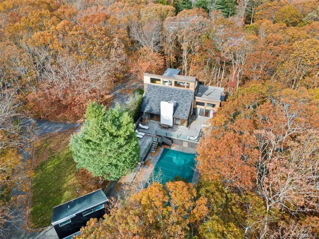 an aerial view of a house with a yard