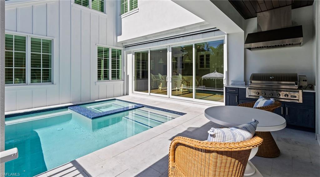 844 8th Street South Naples, FL 34102 - Photo 3 of 13 a outdoor living space with furniture and a fireplace