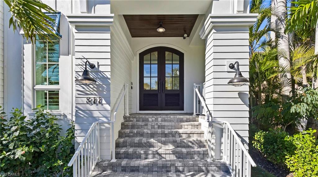 844 8th Street South Naples, FL 34102 - Photo 4 of 13 a front view of a house with a garden