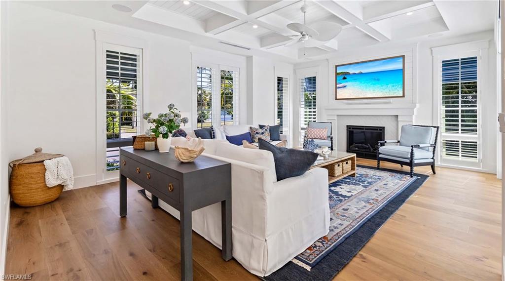 844 8th Street South Naples, FL 34102 - Photo 6 of 13 a living room with furniture fireplace and wooden floor