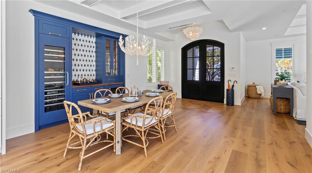 844 8th Street South Naples, FL 34102 - Photo 7 of 13 a view of a dining room with furniture window and wooden floor