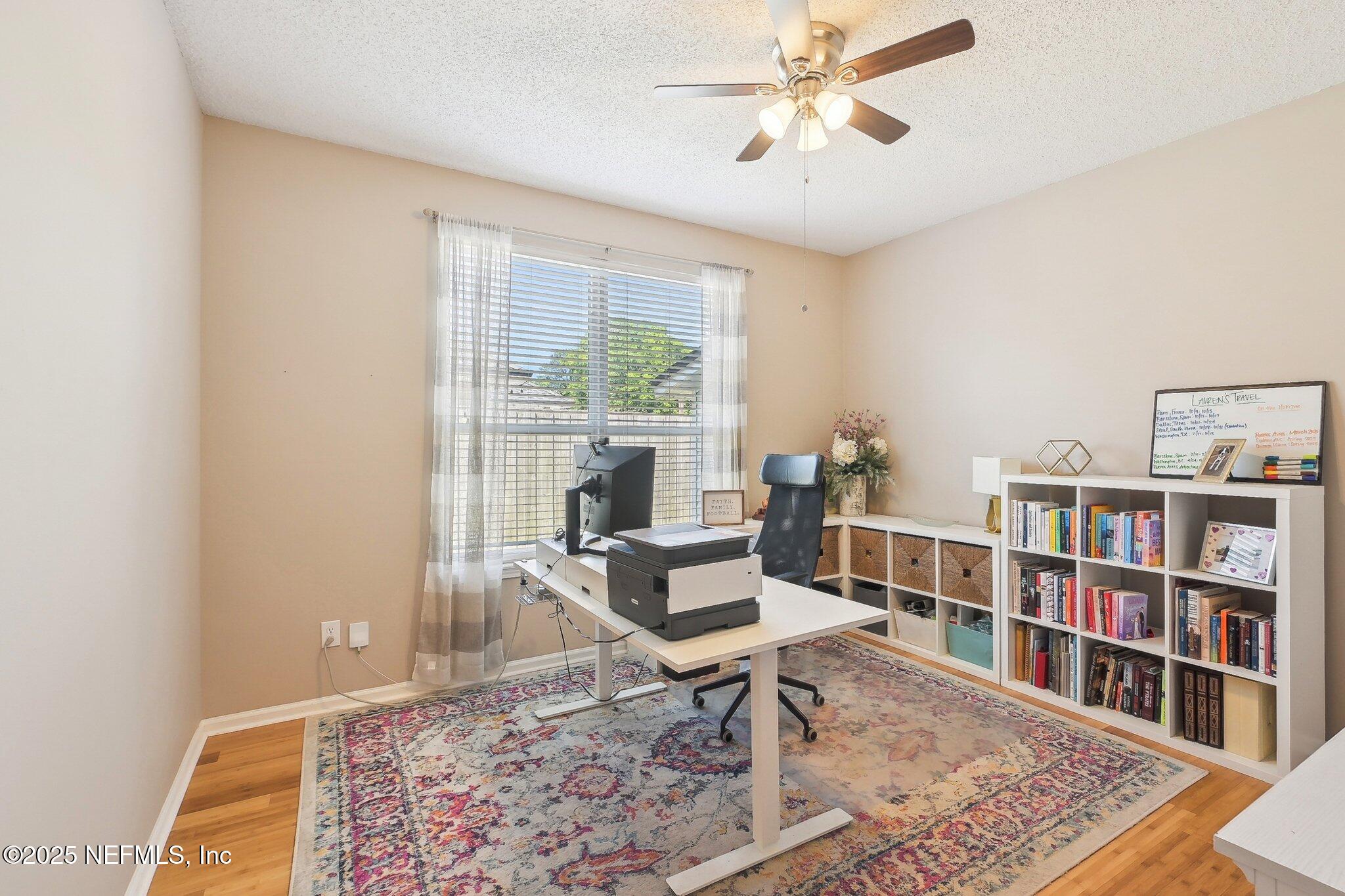 12529 Cliffrose Trail Jacksonville, FL 32225 - Photo 11 of 23 a living room with furniture and a book shelf