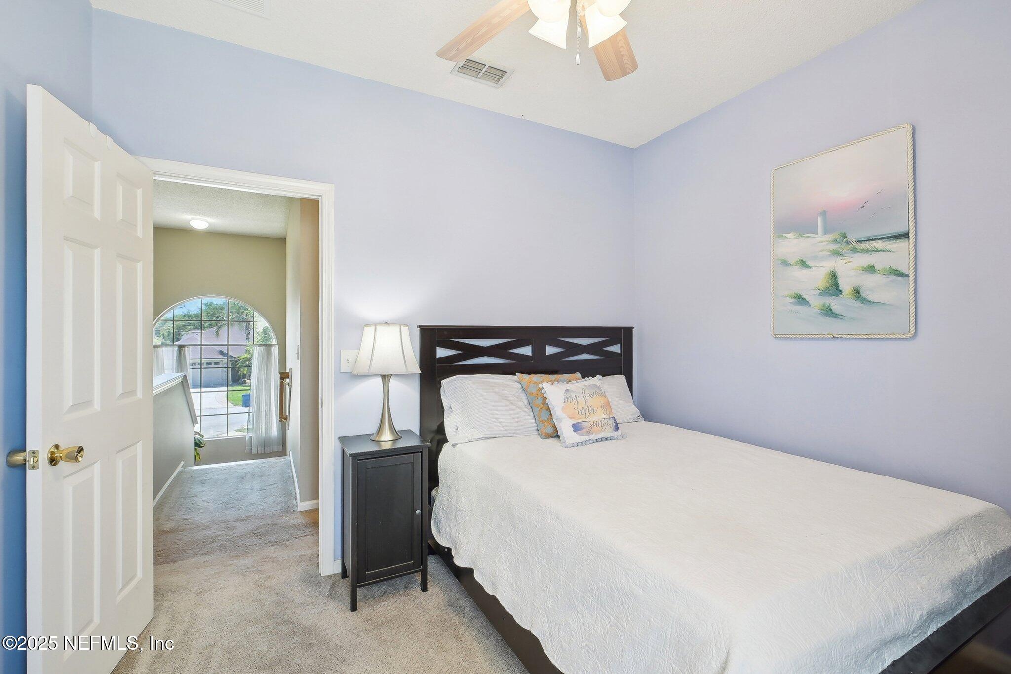 12529 Cliffrose Trail Jacksonville, FL 32225 - Photo 12 of 23 a bedroom with a bed and a painting on the wall