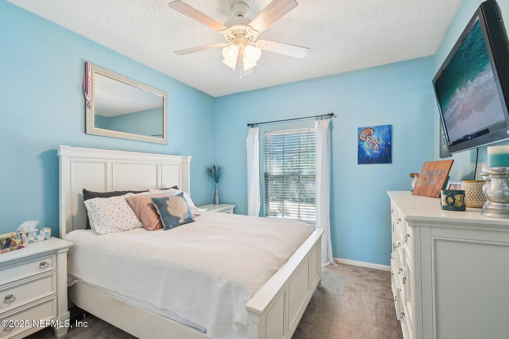 12529 Cliffrose Trail Jacksonville, FL 32225 - Photo 14 of 23 a bedroom with a bed and a flat screen tv