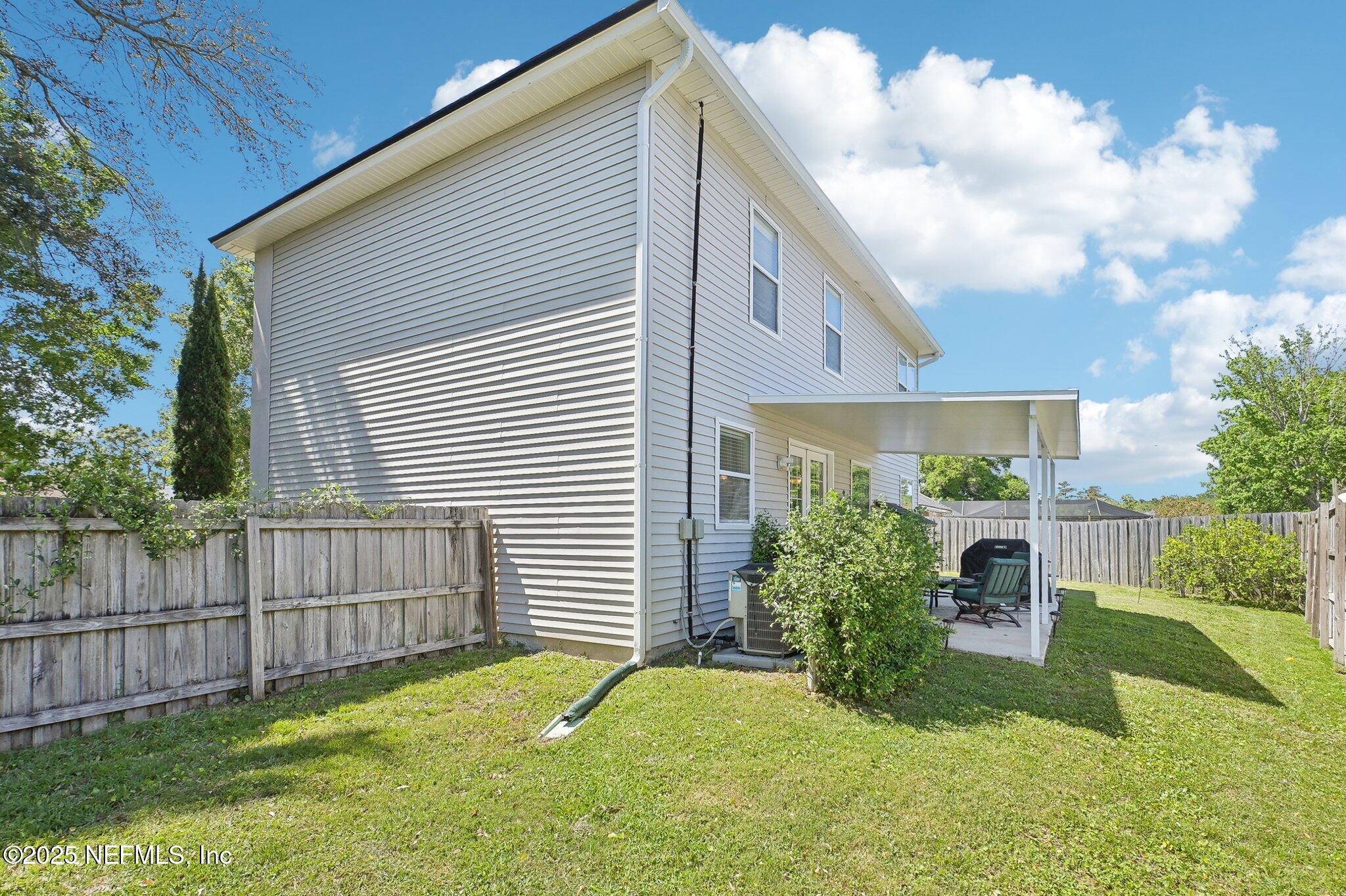 12529 Cliffrose Trail Jacksonville, FL 32225 - Photo 20 of 23 a view of a house with a yard and a garden