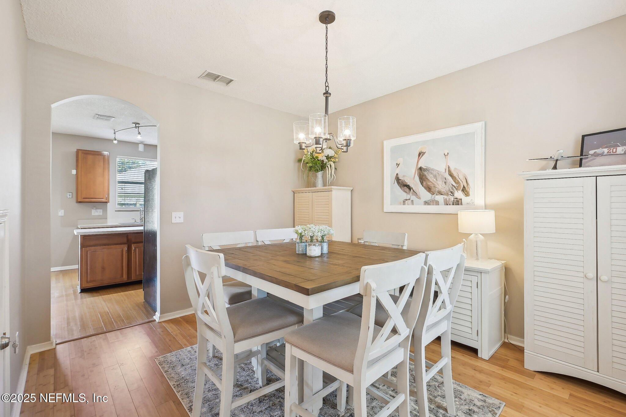 12529 Cliffrose Trail Jacksonville, FL 32225 - Photo 5 of 23 a view of a dining room with furniture and wooden floor