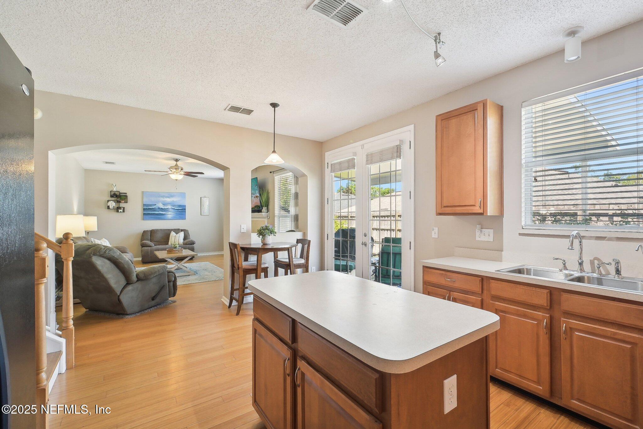 12529 Cliffrose Trail Jacksonville, FL 32225 - Photo 8 of 23 a kitchen with granite countertop a sink a counter space dining table and chairs