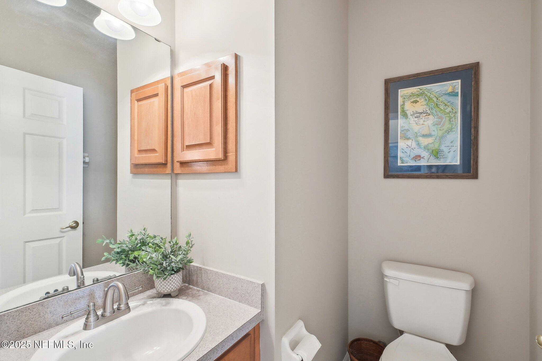 12529 Cliffrose Trail Jacksonville, FL 32225 - Photo 10 of 23 a bathroom with a toilet a sink and a mirror