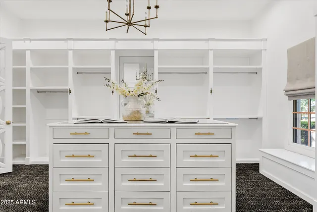 a view of a backyard with wooden fence and a lawn chairs