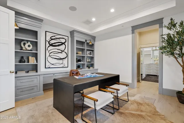 a living room with a bed and a large window