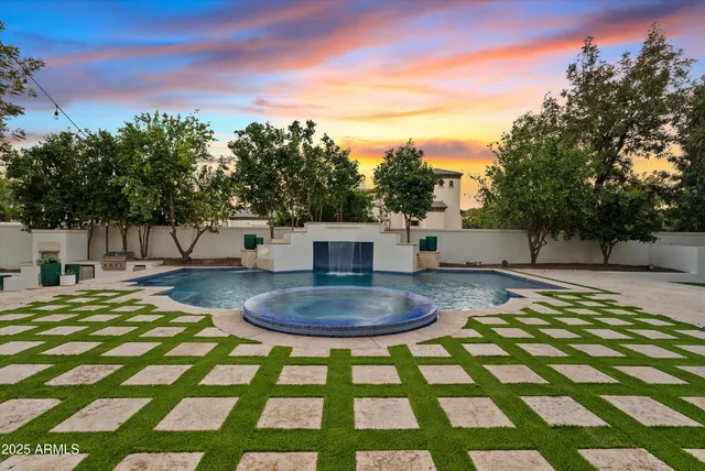 a kitchen with stainless steel appliances granite countertop a white table and chairs in it