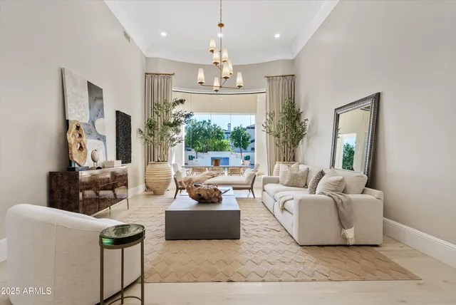 a kitchen with stainless steel appliances granite countertop a sink a stove a refrigerator and white cabinets