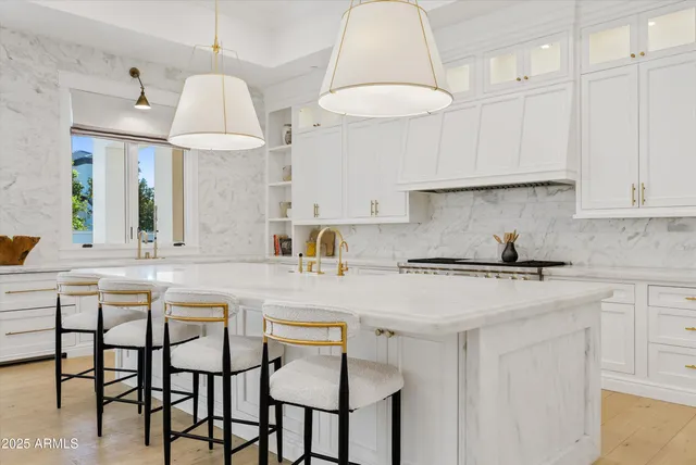 a dining room with couches chairs and large windows