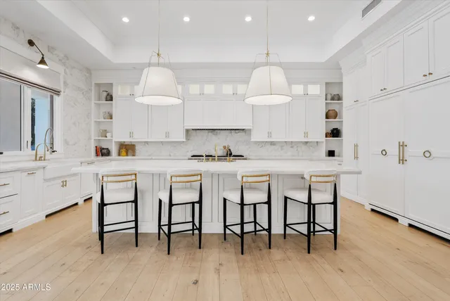 a bedroom with a large bed and a fireplace