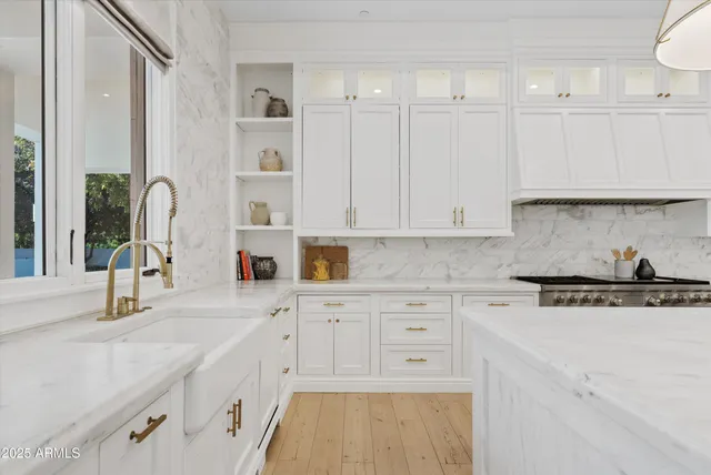 a living room with fireplace furniture and a large window