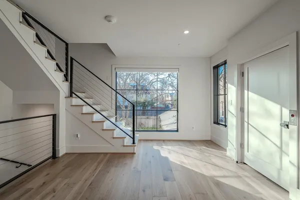 a view of entryway with wooden floor and stairs