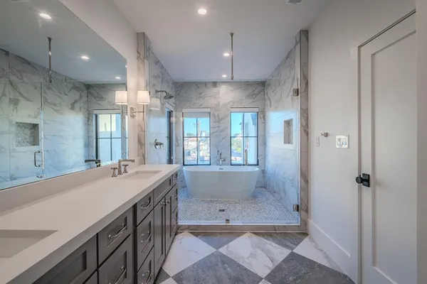 a bathroom with a granite countertop sink a large mirror and shower