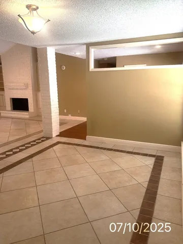 a view of a livingroom with an empty space and a window