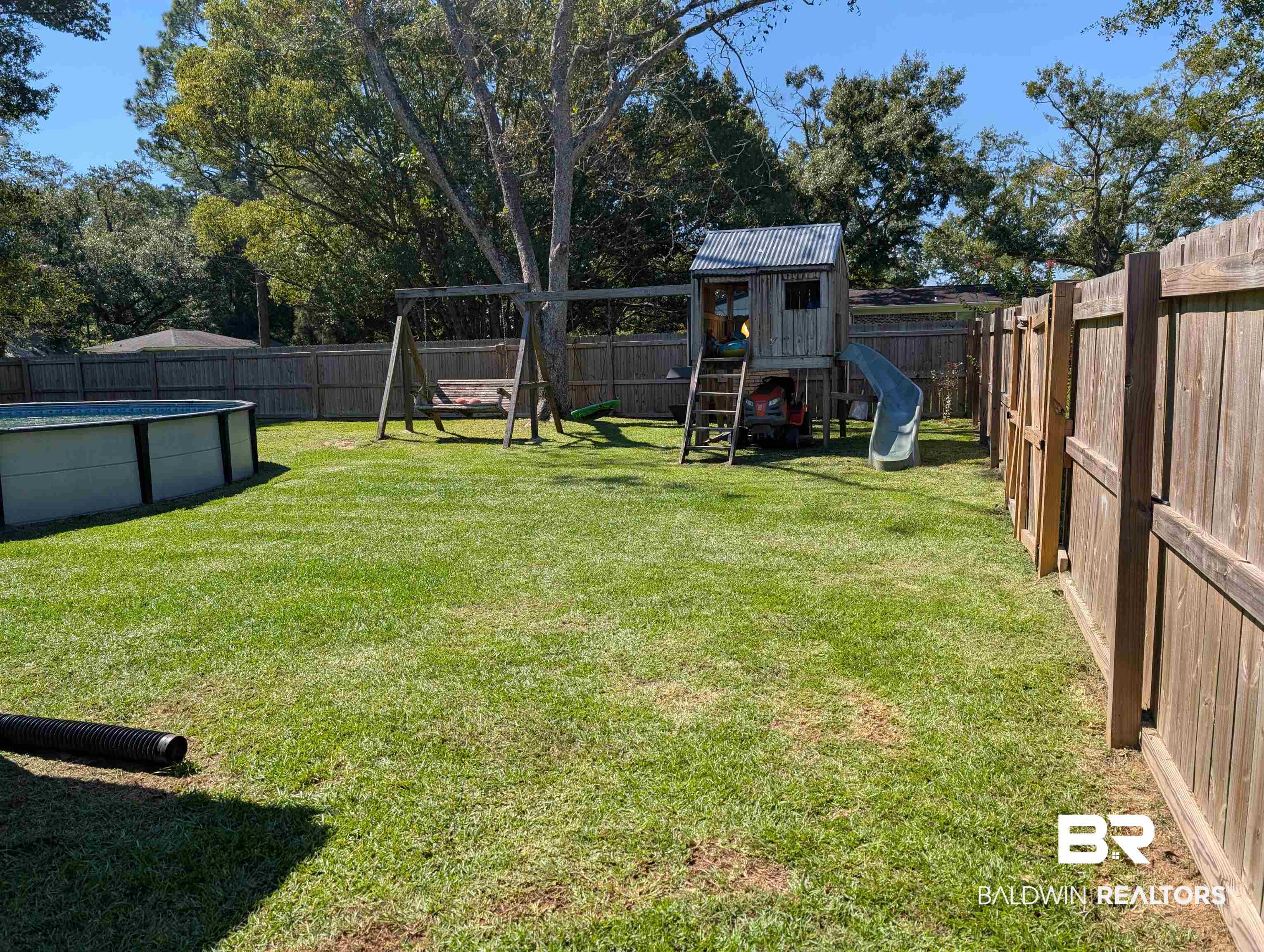 22103 2nd Street Silverhill, AL 36576 - Photo 3 of 10 View of yard with a fenced in pool and a playground