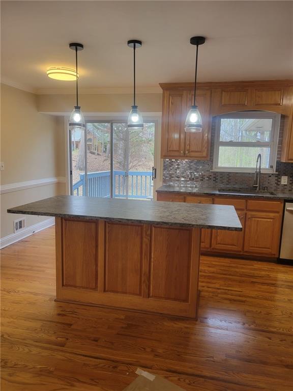 3370 Westbrook Road Suwanee, GA 30024 - Photo 19 of 43 a kitchen with stainless steel appliances granite countertop a sink a microwave cabinets and wooden floor